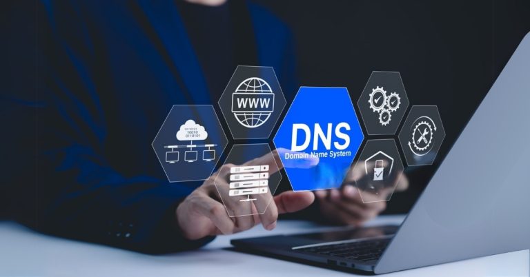 Business professional interacting with DNS settings on a laptop. Learn how to create professional emails with your domain name using DNS configuration.